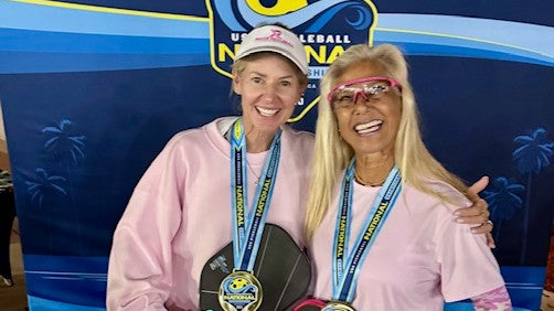Anna Shirley and Beth Bellamy wearing medals and holding paddles at the National Championships
