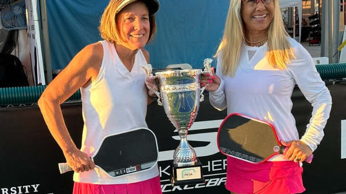 Anna Shirley and her doubles partner holding paddles, medals and a trophy at the APP Mesa Open