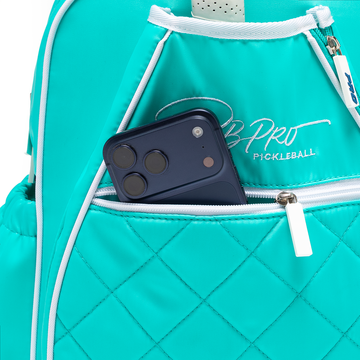 Mint PBPRO Signature pickleball backpack, close-up of front pocket holding a phone