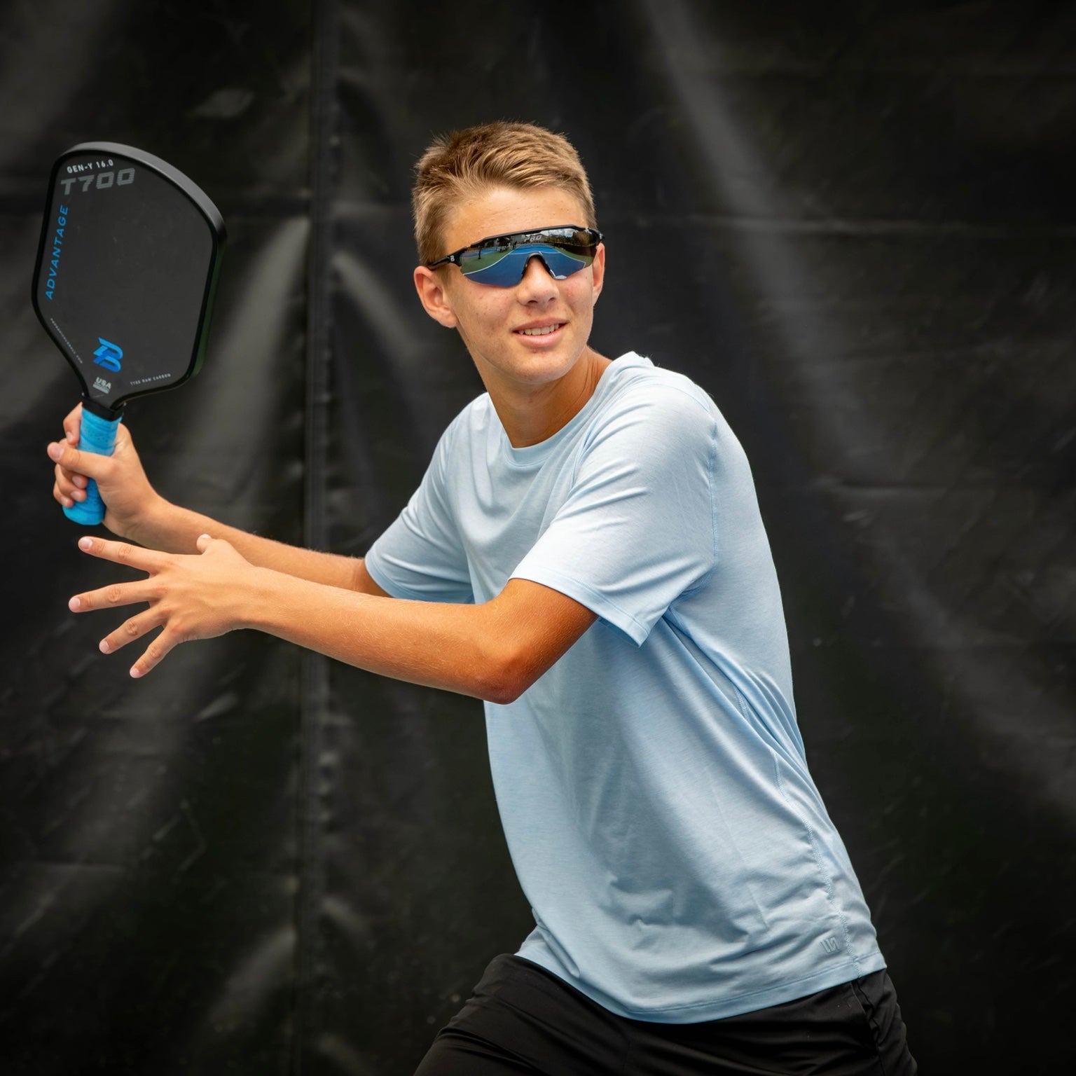 Improving intermediate player preparing a two-handed backhand with a PBPRO Advantage paddle